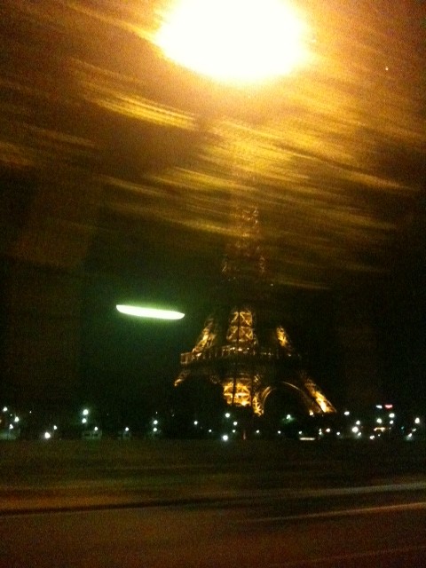 The Eiffel tower seen from a taxi on Saturday night